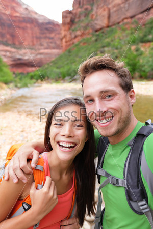 Happy couple taking selfie photo hiking