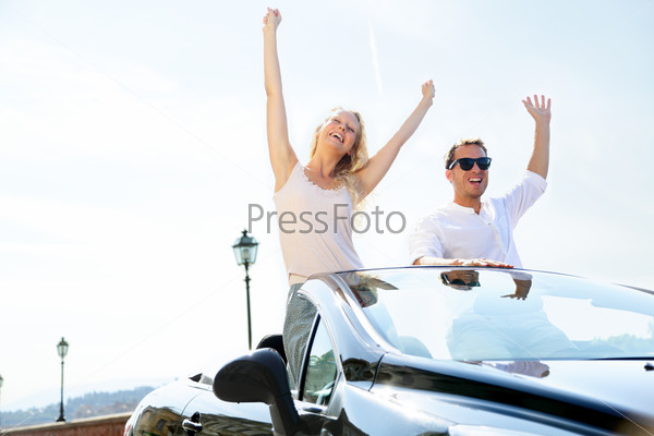 Stock Photo: Happy people in car driving on road trip