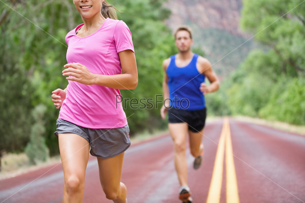 Marathon running athletes couple training on road