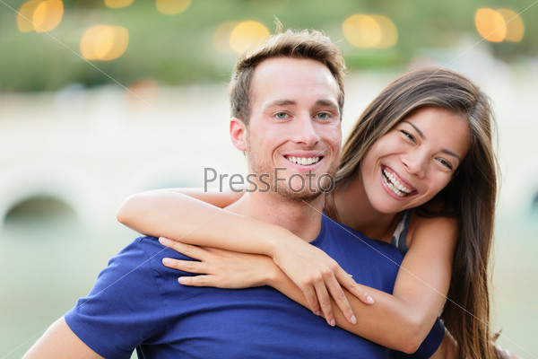Young couple. Happy young college university students smiling at camera portrait. Multiracial woman and man in love.