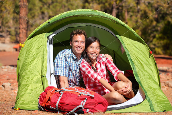 Couple camping in tent happy in romance