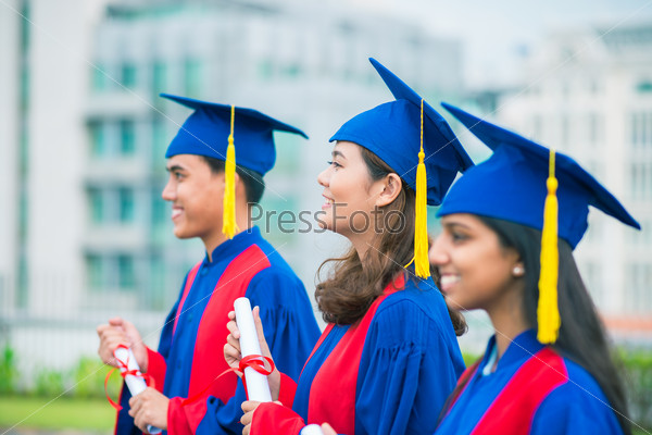 Graduated students standing in a row at attention