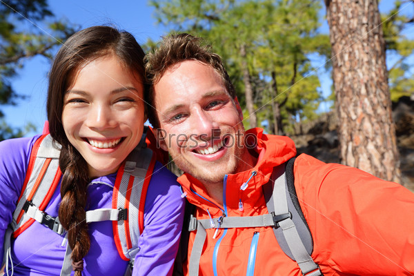 Selfie couple taking self-portrait hiking candid