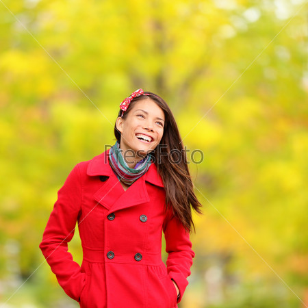 Autumn people - fall woman smiling happy walking in colorful forest foliage.