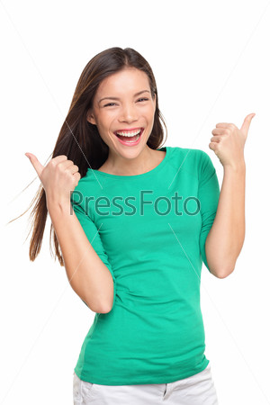 Thumbs up happy excited woman isolated on white background in green t-shirt. Cheerful joyful and elated girl looking at camera. Multiracial Asian Caucasian girl in her twenties.
