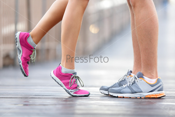 Love Sport Concept - Running Couple Kissing. Closeup Of Running Shoes And Girl Standing On Toes To Kiss Boyfriend During Jogging Workout Training Outdoors On Brooklyn Bridge, New York City.