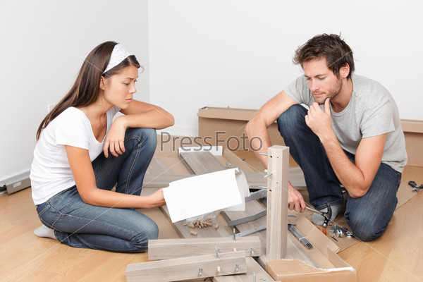 Couple moving in assembling bed furniture
