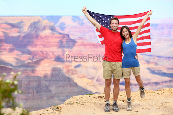 USA travel tourist couple holding american flag