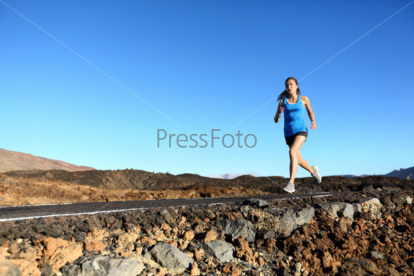 Running woman - female runner jogging outdoors on road training for marathon run as part of healthy lifestyle outdoor workout in summer. Mixed race Asian Caucasian model.