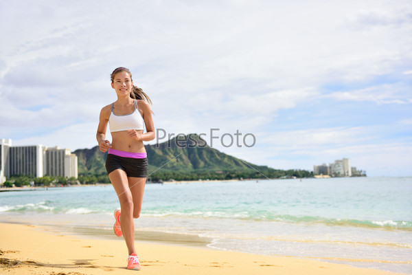 Sport running fitness woman jogging on beach run. Female athlete runner jogger training living healthy active exercise lifestyle exercising outdoor on Waikiki Beach, Honolulu, Oahu, Hawaii, USA.
