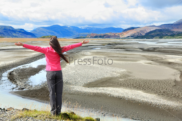 Woman enjoying view of Iceland black sand dunes in south Icelandic nature landscape. Serene person relaxing soaking in the natural beauty. Tourist visiting landmarks tourists attractions.