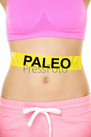 Paleo diet concept - closeup of woman\'s stomach to show eating concept. New trend in nutrition based on hunter gatherer consumption of proteins. Yellow label as warning or caution applied on body.