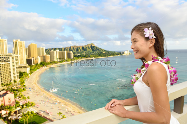 Hawaii Travel - Asian tourist on Hawaiian holidays looking at Waikiki beach and Diamond Head in the background, Honolulu City, Oahu, USA from hotel room in luxury resort.