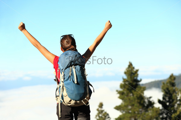 Success. Successful happy hiker cheering having reached\
summit and goal. Young woman hiking in mountain nature\
joyful.