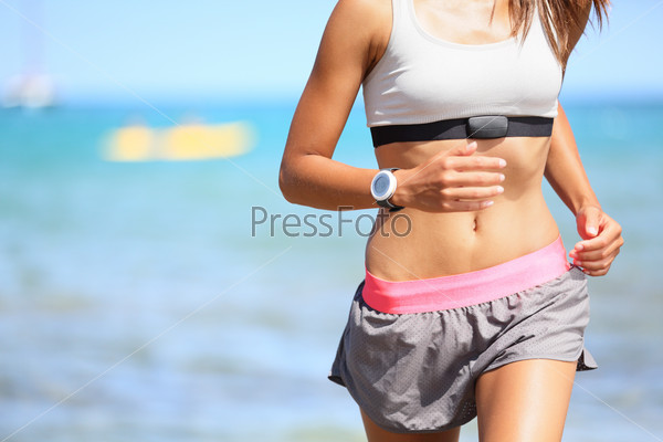 Runner woman with heart rate monitor running