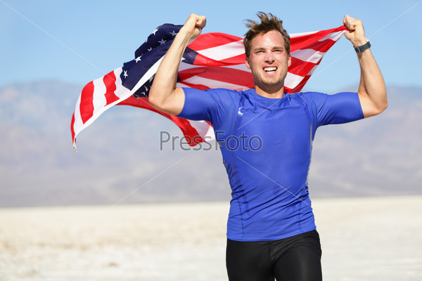 Success - winning runner cheering with USA flag celebrating victory. Fit American male winner fitness running model in celebration of success win. Face expression showing successful achievement.