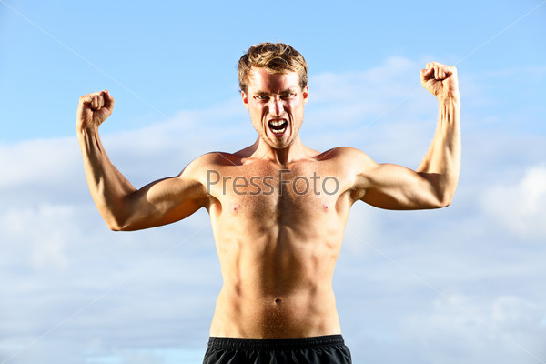 Strength - strong aggressive fitness man flexing muscles showing power pose outside. Muscular fit male fitness man celebrating success macho style.