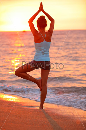 Yoga Meditation Woman Meditating At Beach Sunset Relaxing In Yoga Posture, Tree Pose, Vrksasana. Relaxed Serene Asian Woman Enjoying Evening Sun Light And Sunshine. From Big Island, Hawaii, Usa.