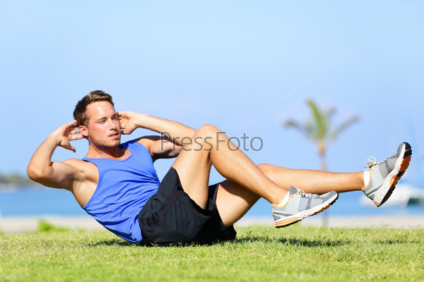 Sit ups - fitness man exercising sit up outside