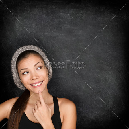 Thinking woman by blackboard