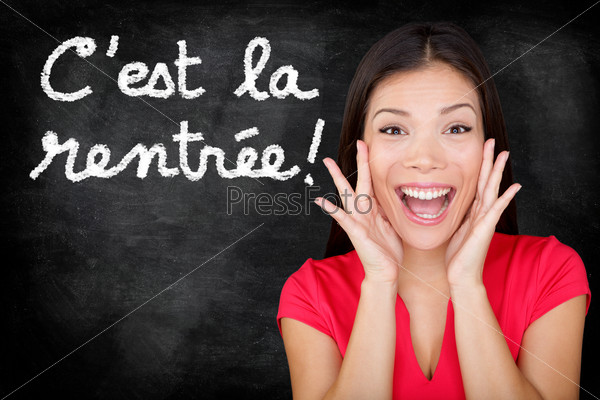 Cest la Rentree Scolaire - French student screaming happy\
Back to School written in French on blackboard by woman teacher.\
Smiling happy female teaching French language or university college\
student