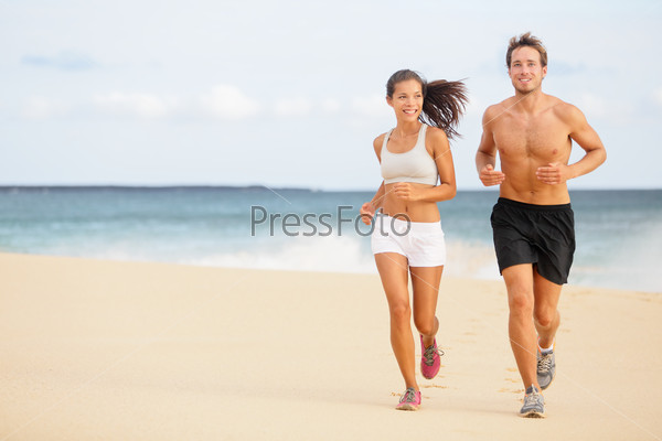 Runners - Young couple running on beach