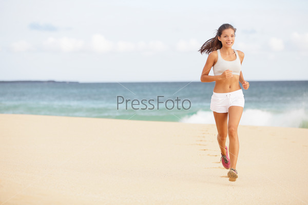 Running woman jogging on beach