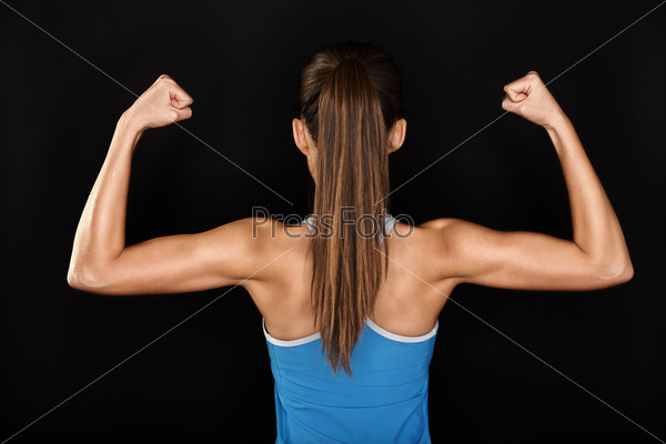 Strong fitness woman showing back biceps muscles - Stock Image - Everypixel