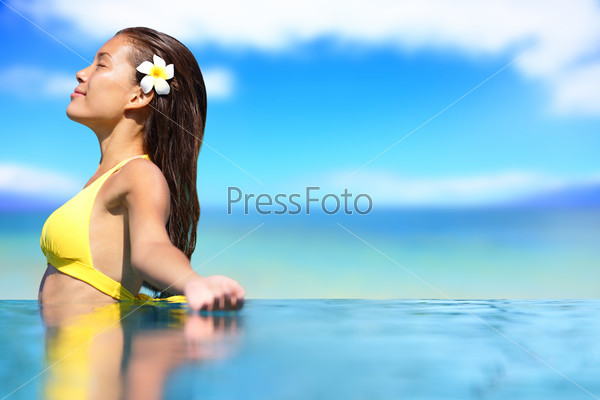 Relaxing Serene Woman At Travel Spa Resort Pool. Happy Blissful Asian Young Woman In Bikini Enjoying Sun On Holidays On Hawaii.