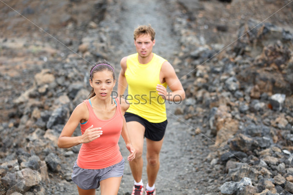 Runners couple running on trail in cross country