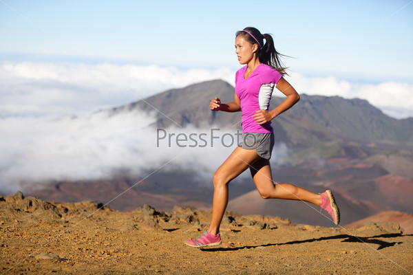 Runner Woman Athlete Running Sprinting Fast. Female Sport Fitness Model Training A Sprint In Amazing Nature Landscape Outdoors At Speed Wearing Sporty Runners Clothing Outfit. Mixed Race Asian Woman