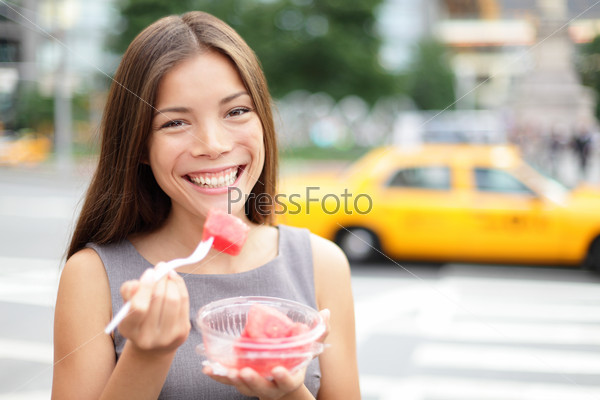 Business woman in New York eating watermelon snack