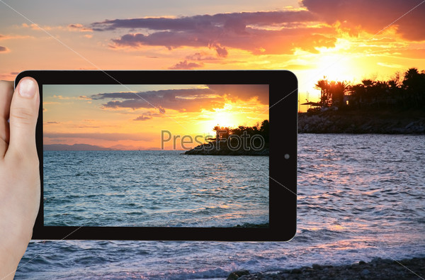 travel concept - tourist taking photo of Gulf of Aegina in Athens on mobile gadget, Greece