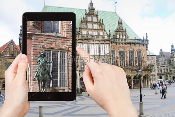 travel concept - tourist taking photo of Bremen Town Hall on mobile gadget, Germany