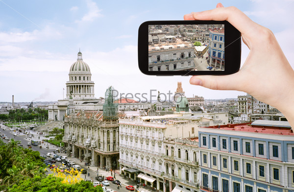 travel concept - tourist taking photo of center old Havana on mobile gadget, Cuba