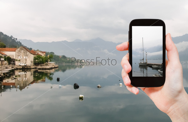 travel concept - tourist taking photo of Bay of Kotor on mobile gadget, Montenegro