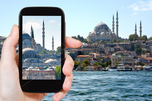 travel concept - tourist taking photo of Istanbul skyline on mobile gadget, Turkey