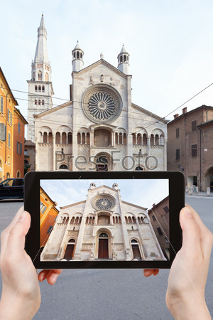 travel concept - tourist taking photo of Modena Cathedral on mobile gadget, Italy