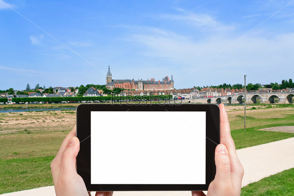 travel concept - tourist photograph river Loire and Gien city, France in summer day on tablet pc with cut out screen with blank place for advertising logo