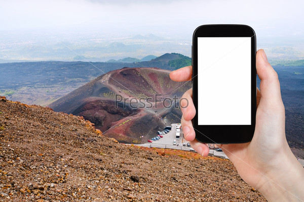 travel concept - tourist photograph tourist station Rifugio Sapienza on Etna in Sicily, Italy on smartphone with cut out screen with blank place for advertising logo