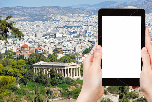 travel concept - tourist photograph Athens city with Temple of Hephaestus from Acropolis hill, Greece on tablet pc with cut out screen with blank place for advertising logo