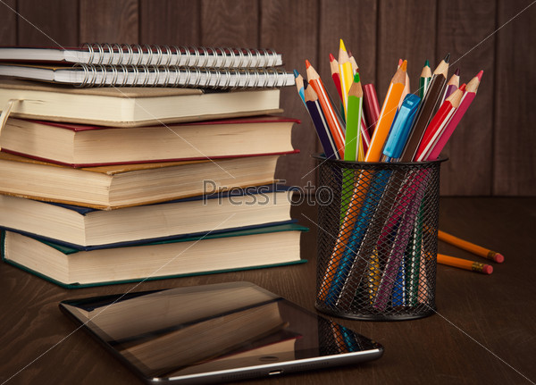 stack of books, digital tablet and pencils. education concept