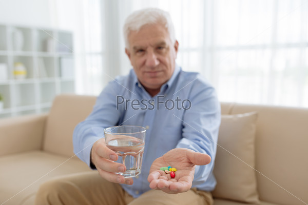 Senior man with colorful pills