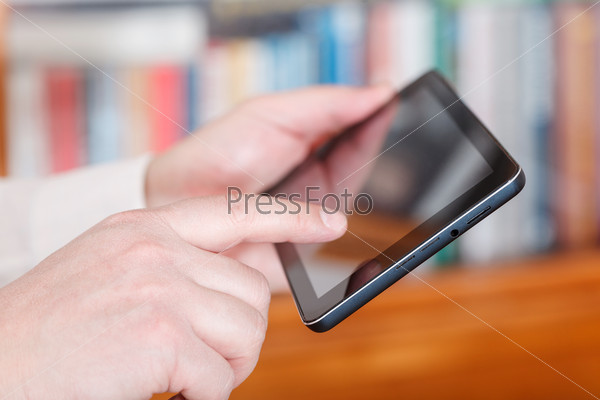 Businessman finger touching tablet pc screen in office room, stock photo