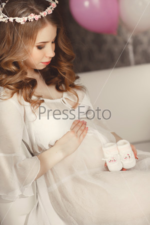 Pregnant Happy smiling Woman caressing her belly. Mom Expecting Baby. Pregnant Woman Belly. Pregnancy. Beautiful Pregnant Woman. Maternity concept. Baby Shower