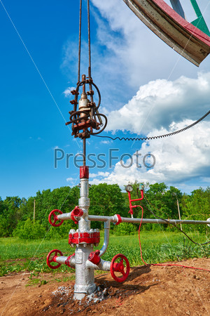 Oil pumping station machine rocking spring against the sky