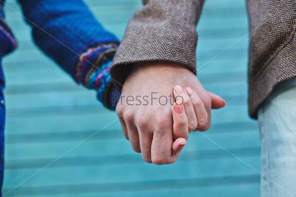 Man and woman holding by hands