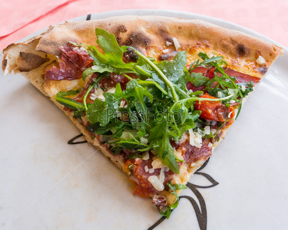 In the picture Italian pizza view from top with Arcula,cherry tomato,tomato,mozzarella,cheese,parmesan and Bresaola.