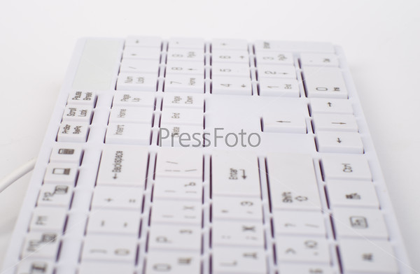 Computer keyboard with wire on isolated white background, close up view