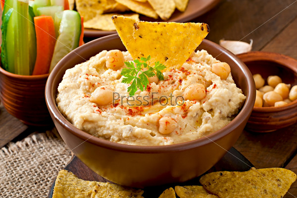 Healthy homemade  hummus with vegetables, olive oil and pita chips